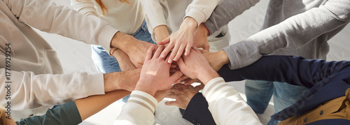 Obraz na płótnie Close-up of business team stacking hands together in circle in office, promoting group teamwork, enhancing a collaborative spirit with diverse people, unity and shared success in a space