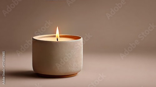 Wallpaper Mural Vanilla scented candle burning on beige background concept. A cozy candle in a textured holder, illuminating a warm atmosphere. Torontodigital.ca