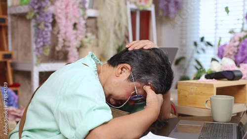Worried senior woman, florist small business owner overwhelmed with stress, closed flower shop, hand on head in frustration, financial loss, business crisis, aging struggling with financial debt alone