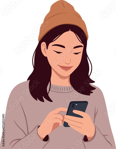 Young Woman In Beanie And Sweater Texting On Phone