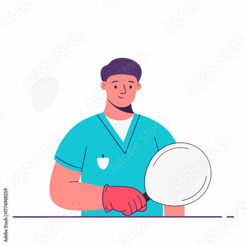A male doctor in scrubs holding a mask for medical procedure