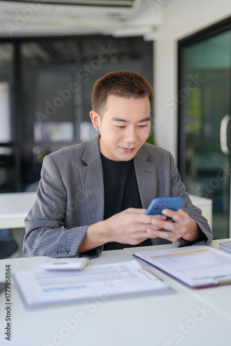 Asian Businessman with Smartphone working mobile devices cell telephone technology e-commerce smartphone business professional investor working new start up project