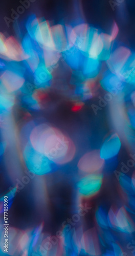 Blur lens leak. Flare blend. Blue green red neon light mix color. Faceted circle prism shimmering reflection texture abstract dark background.