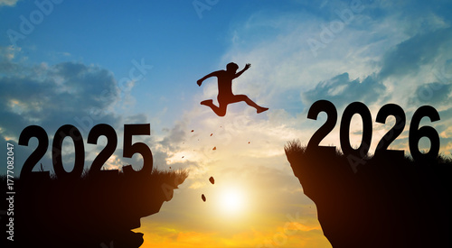 Happy new year in 2026. Man jumping across the gap from 2025 to 2026 cliff with Sunset and Twilight Sky background.