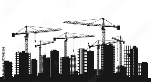 Construction site with silhouette of buildings and multiple cranes against a skyline