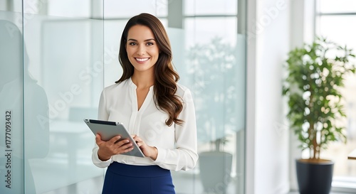 Smiling Businesswoman Holding Tablet in Modern Office.