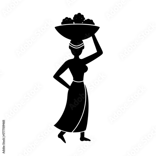 Silhouette of woman carrying a basket on her head in traditional african dress