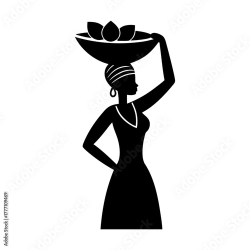 Silhouette of an african woman carrying a bowl of fruit on her head in black and white
