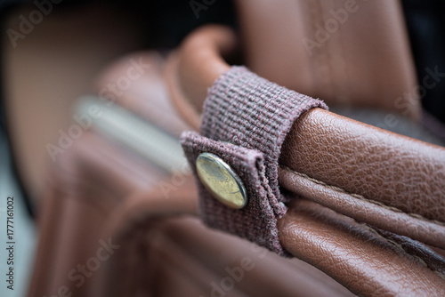 Silver button fastening for backpack straps