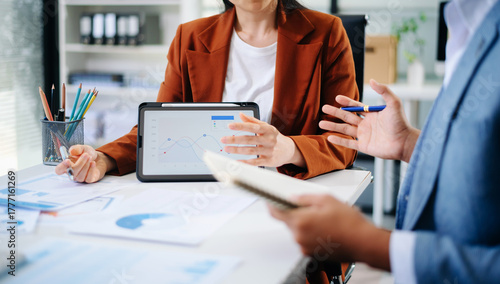 Business people meeting at office writing notes about sticky notes Laptop,tablet Planning and Brainstorming Strategies of Colleagues