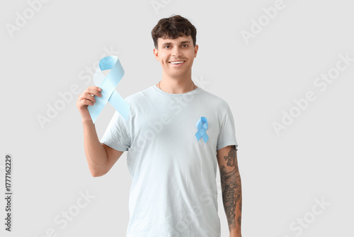 Young man with blue ribbon ...