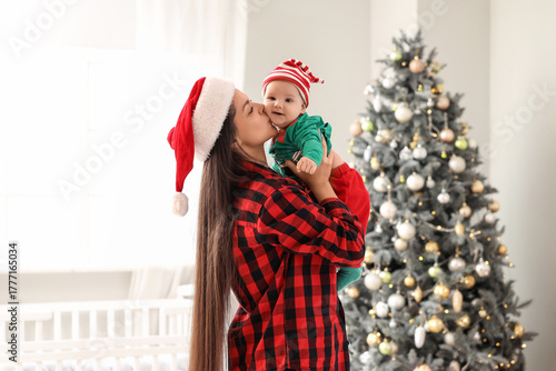 Mother kissing her little b...