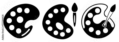 Three black artist palettes with paint circles and brushes
