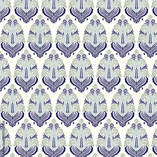 An elegant, symmetrical floral motif in a paisley or Buta shape. This ornate damask-style design features intricate leaves in navy blue, grey, and cream. Isolated traditional element.