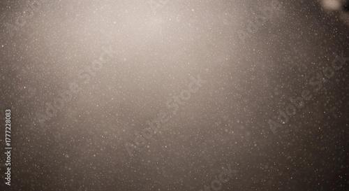 Abstract background of dust particles floating in the air, illuminated by soft light, creating a dreamy and ethereal atmosphere