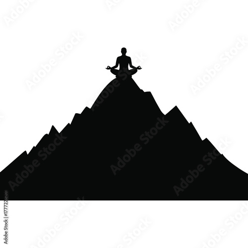 Silhouette of a person meditating atop a mountain peak