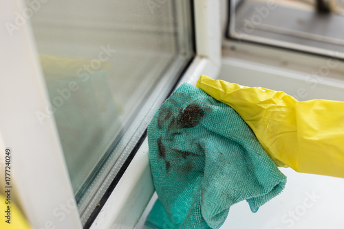 Used microfiber cloth with black dust and grime after wiping a window frame, showing removed residue and cleaning result.
