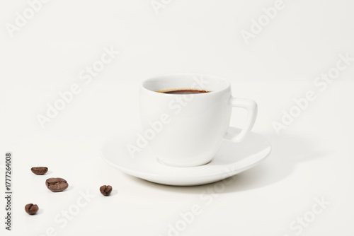 A cup of coffee and coffee beans on the table.  Copy space of your text.