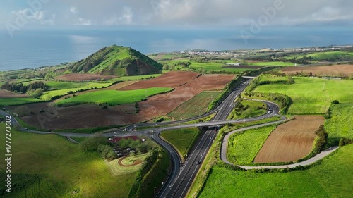 Aerial landscape with modern road infrastructure crossing rural farmland on Sao Miguel Island, Azores