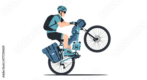 Adventurous cyclist skillfully performing a wheelie with fully loaded touring bicycle