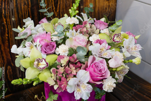Luxury floral arrangement: pink roses, orchids, hydrangea in velvet box bouquet