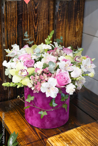 Luxury floral arrangement: pink roses, orchids, hydrangea in velvet box bouquet