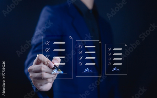 Businessman using digital pen to sign electronic documents on virtual checklist, concept of e-signature, online approval, and paperless document management in modern business technology.