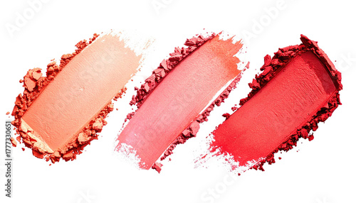 Three coral-hued powder swatches isolated on a black background