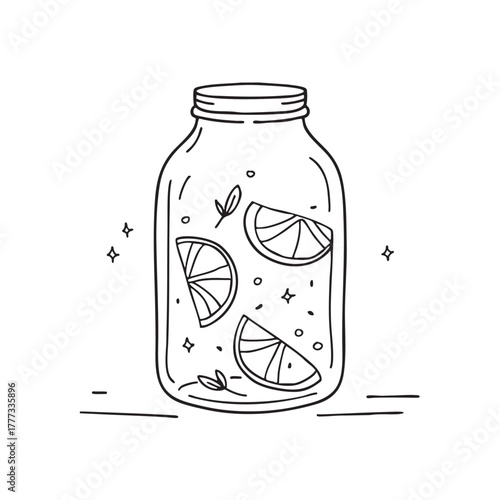 Glass jar filled with preserved lemons in brine