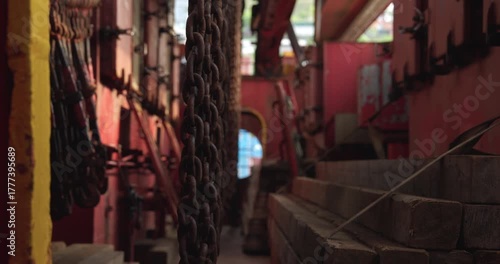 Rusty chains bunch near construction materials on cargo ship vessel. Freights transporting and loading equipment on marine industrial dock