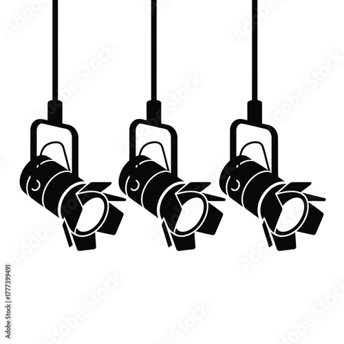 Three hanging stage spotlights illuminating a dark space