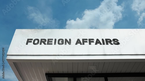 Foreign Affairs word sign prominently displayed on the official government building facade beneath a clear blue sky, signifying the central department managing international relations, diplomacy