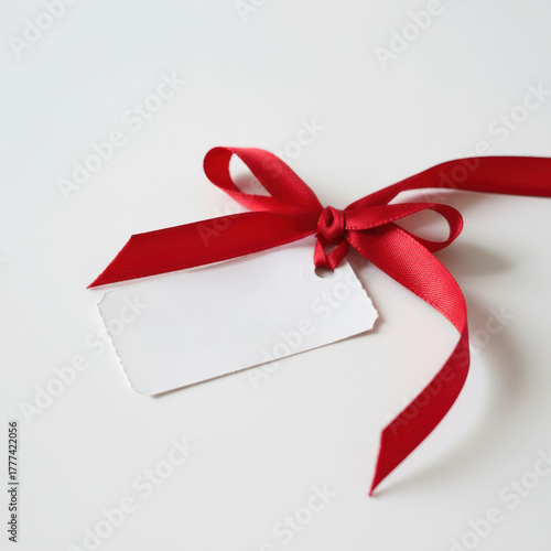 Red ribbon gift tag sale charm on white