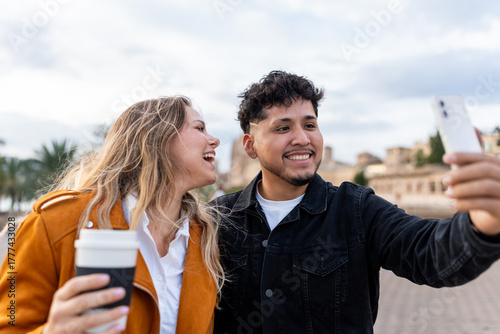 Young couple taking selfie enjoying urban lifestyle