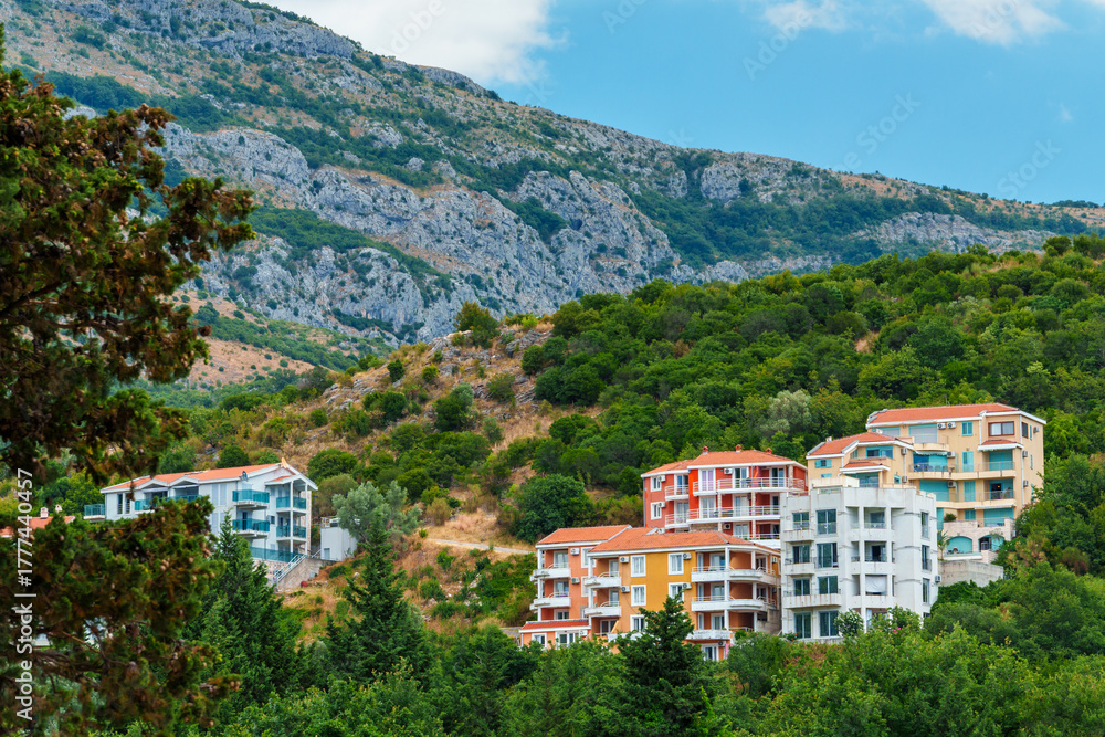 Fototapeta premium hotels of the resort town against the backdrop of mountains covered with forest, architecture, Petrovac city, Montenegro