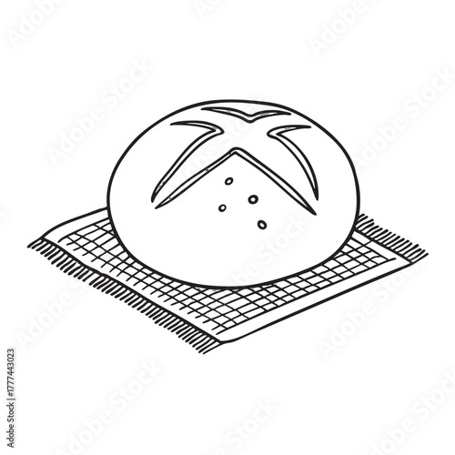 Round crusty bread set atop a woven mat