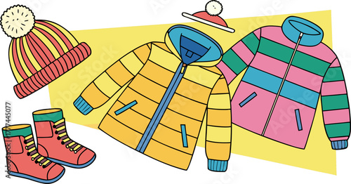 A product shot featuring a collection of children's winter clothing items arranged on a solid blue backdrop. The main subjects are various brightly colored winter jackets, knitted hats, scarves, and p