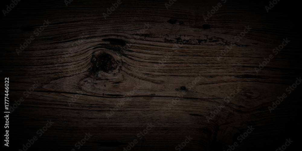Fototapeta premium Horizontal close-up smooth dark wood featuring rich. Strong, soft vignette that fades edges into absolute black creating moody sophisticated and luxurious atmosphere elegant websites digital vintage