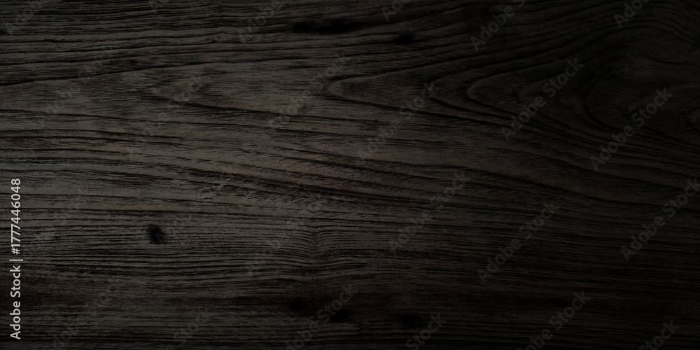 Fototapeta premium Horizontal close-up smooth dark wood featuring rich. Strong, soft vignette that fades edges into absolute black creating moody sophisticated and luxurious atmosphere elegant websites digital vintage