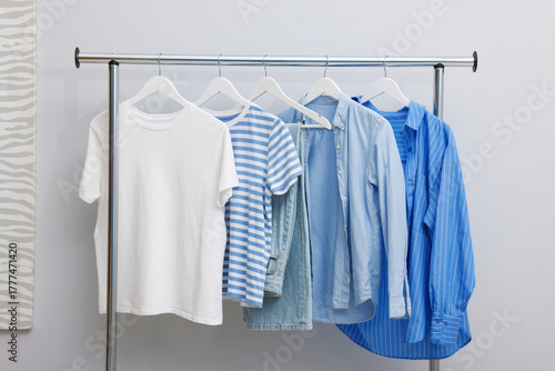 Wallpaper Mural Different stylish clothes hanging on rack near light wall indoors Torontodigital.ca