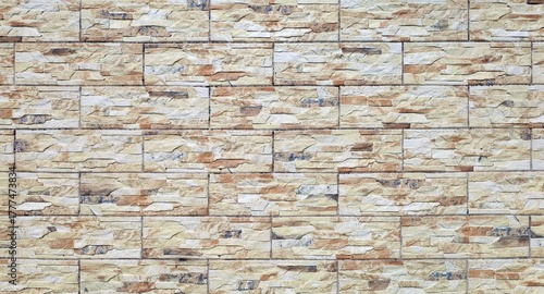 Stoneware coating wall with rock effect. Colors are flaxen yellow, brown and white. Background and texture.