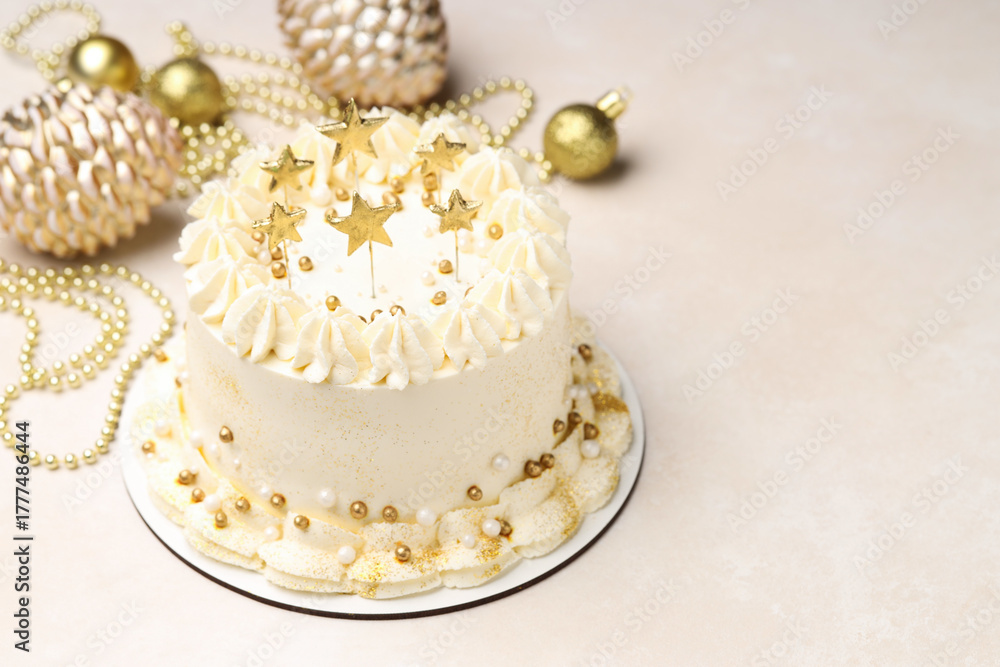 Fototapeta premium Delicious cake with Christmas decor on beige table, closeup. Space for text