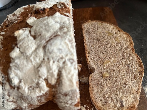 freshly baked sourdough bread sliced on wooden cutting board, directly above