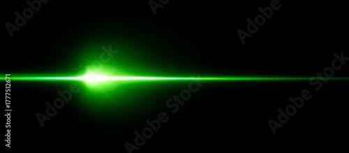A vibrant green laser beam streaks horizontally across a black background, creating a futuristic effect