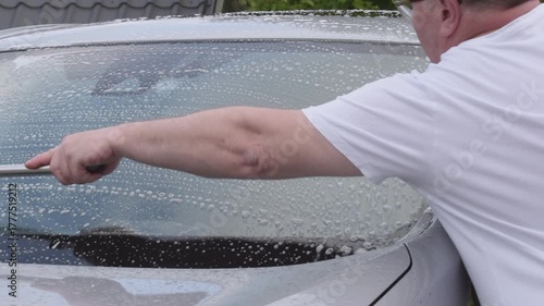 Detailed car windshield and roof cleaning process for a clear view
