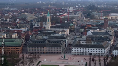 Elevated panoramic view of Karlsruhe cityscape in Germany, featuring Palace tower surrounded by bare trees in palace garden