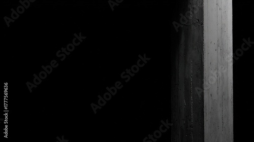 negative. Minimalist architectural column detail in concrete with dramatic side lighting and monochrome tones. real-estate listings.