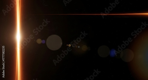 Abstract orange light streak on black background with lens flares and bokeh