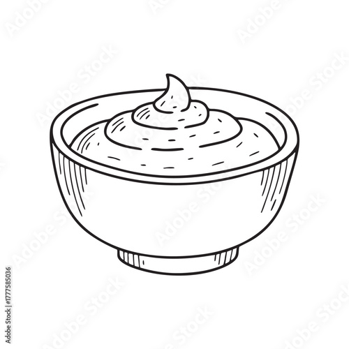 Ceramic bowl holding a smooth dip made from green herbs