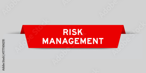 Red color inserted label with word risk management on gray background